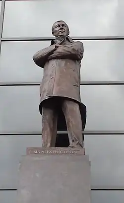statue of man in long coat