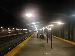 An underground railway platform with hazy halos around the overhead lights