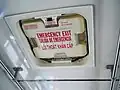 Public bus top emergency exit for when the sides are blocked, in English, Spanish and Vietnamese
