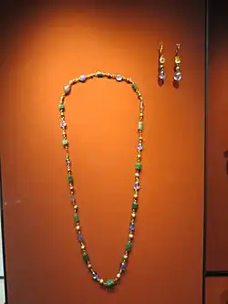 One of the necklaces (made of pearls and sapphires) next to the pair of ear rings