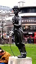 The statue's second location in Leicester Square, in 2008, with the Swiss Centre behind