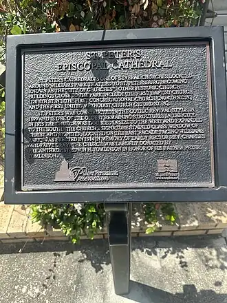 Free-standing historic marker, erected in 2010 which reads: “St. Peter’s Episocal Cathedral St. Peter’s Cathedral is one of several churches located around Williams Park that led to St. Petersburg becoming known as the “City of Churches.” Other historic church buildings close to the park include the First Baptist Church (120 4th St N), The First Congregational Church (240 4th St N) and the First United Methodist Church (212 3rd St N) St. Peter’s was constructed in the gothic revival style in 1899 and is one of the oldest remaining structures in the city. In 1925 the church was doubled in size to the west and expanded to the south. The church’s signature stained glass window of Christ and St. Peter, located on the east façade facing Williams Park, was erected in 1914 in memory of early rector Rev. Charles McIlvaine Gray. The church was largely donated by Philanthropist Edwin H. Tomlinson in honor his father Peter Tomlinson.”
