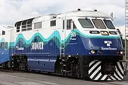 A large locomotive in the Sounder livery with "905" painted on the side