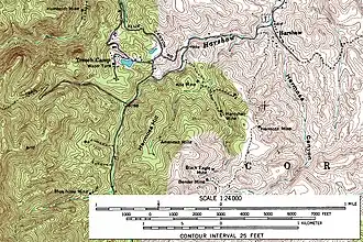 A black and white line-drawn map of a section of southeastern Arizona, oriented with north at the top of the page. Most of the labels denote mines, rivers, and peaks, and only a handful are plotted. While the labels are few, the map is entirely covered with wavy lines signifying the elevation and topography of the region. In the northeast corner of the map, near the banks of Harshaw Creek, lies the town of Harshaw. In the mountains to the southwest of town lie various area mines, including the Hardshell, Hermosa, Alta, American, Black Eagle, and Bender.