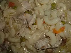 Homemade chicken soup with elbow macaroni, chicken pieces, carrots and celery