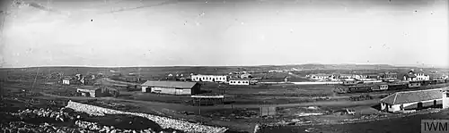 Panorama photo of groups of trains and buildings