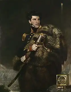 A man in a heavily embroidered uniform looks right, graping a large sword. A navigational instrument stands on a table, lower right.