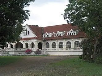 Exterior of a long, white colonial-style building