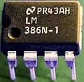 A plastic dual-in-line package containing an analog integrated circuit.This can be installed in a socket or directly soldered to a printed circuit board.