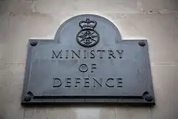 The Ministry of Defence plaque outside the south door of Main Building.