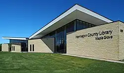Maple Grove branch, a modern cream-colored building.