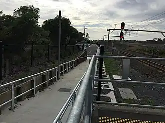 Footpath leading to a carpark. Photo faces east and is taken from platform 1.