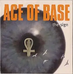 A close-up shot of an eyeball with an ankh inside. The text above reads Ace of Base – The Sign