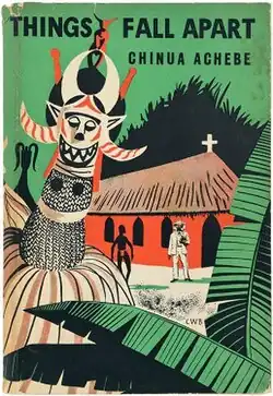 A book cover with the drawing of a traditional masquerade overlapping a local church building with two standing men at the front, and texts "Chinua Achebe" and "Things Fall Apart" written in all capital letter.