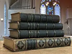 Three copies from three printings of the fifth edition King's Chapel prayer book laying atop one another