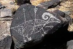 A petroglyph depicting a bighorn sheep; arrows or spears protrude from its body.[4]