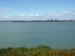 Photograph showing large breakwater constructed at the mouth of Timaru Port.