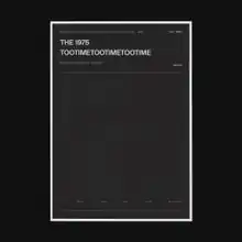 A photo of a gray rectangular box surrounded by a thick black border. Written in the upper left corner of the box are the words "The 1975" and "TooTimeTooTimeTooTime".