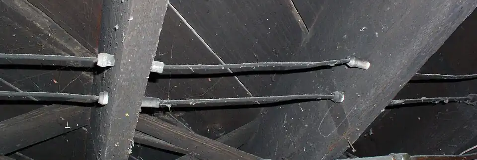 Ceramic tubes protecting wires passing through ceiling joists