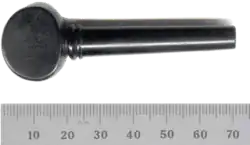 A modern violin tuning peg, not yet shaved to fit an instrument. Note smooth taper and finger grip.