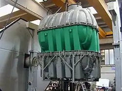 Picture of a plastic tank been removed from its mold after the cooling cycle has been completed.