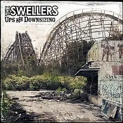 An abandoned theme park with a wooden roller coaster in the background