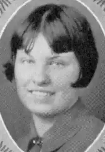 A young white woman with cropped straight dark hair with bangs, from a 1928 yearbook