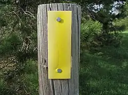 Yellow blazes mark the path of the trail